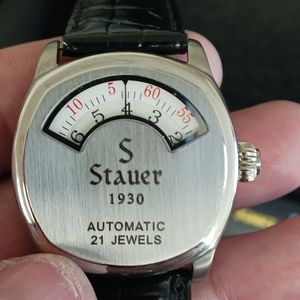 A brand new Stauer mens watch with a black leather band called